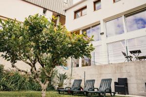 a group of chairs sitting in front of a building at Apartamentos Herança do Vez in Arcos de Valdevez