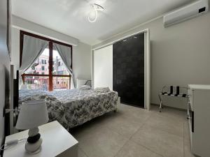 a bedroom with a bed and a large window at Casa Neghelli - Alassio in Alassio