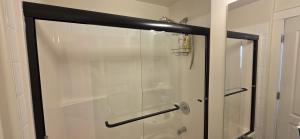 a shower with a glass door in a bathroom at Guest Suite in Langford Victoria in Victoria