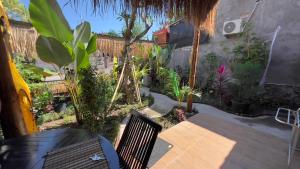 a patio with a table and chairs and plants at Radeva 2 menjangan villa in Banyuwedang