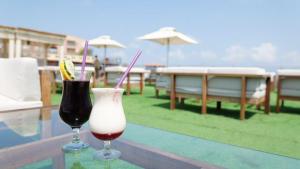 two drinks sitting on a table on a balcony at Les Acacias Hotel Djibouti in Djibouti