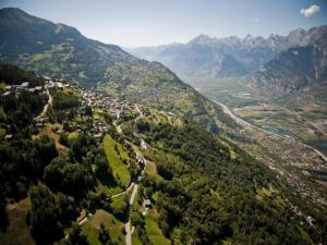 an aerial view of a town in a valley with mountains at Charming apartment with hill view in Veysonnaz