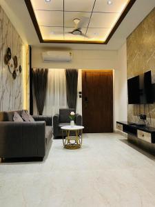 a living room with a couch and a table at The Divine Villa! in Indore