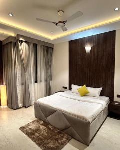 a bedroom with a large bed with a ceiling at The Divine Villa! in Indore