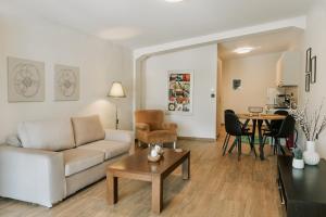 a living room with a couch and a table at Lotos Families Apartments 5 in Konitsa