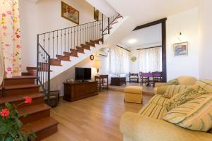 a living room with a staircase and a couch at Orange Park - Agriturismo in Misterbianco