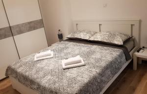 a bedroom with a bed with two towels on it at Apartment KaLea Pula Center By Villas Guide in Pula