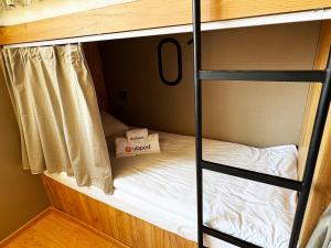 Postel nebo postele na pokoji v ubytování UBPOD- The First Capsule Hotel in Mongolia