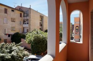 a view of a city from a building with an open window at Colonna Palace Hotel Mediterraneo in Olbia