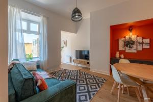 a living room with a blue couch and a table at La Terrasse de La Mandoune - T3 in Montauban