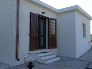 a white house with stairs and a window at B&B La Casa Bianca di Porto Conte in Porto Conte
