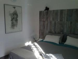 a bedroom with a bed with lights on it at B&B La Casa Bianca di Porto Conte in Porto Conte