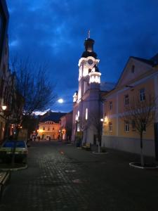 a clock tower in the middle of a city at Кімнати в центрі in Uzhhorod