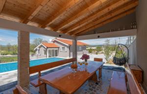 a patio with a table and a swimming pool at Villa Klarita - Makarska by Villas Guide in Drum