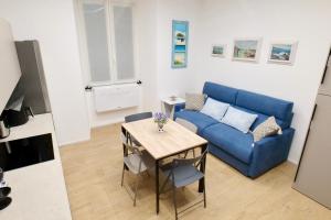 a living room with a blue couch and a table at ValeVacanze in Savona