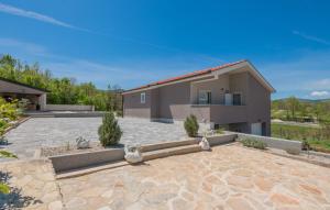 a house with a stone patio in front of a house at Villa Klarita - Makarska by Villas Guide in Drum