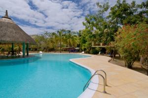 a pool at a resort with a gazebo at Kenville in Cap Malheureux