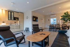 a living room with a table and chairs at Braceli Beach Resort Middle Floor - rentafive in Santa Pola