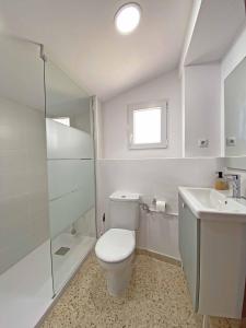 a white bathroom with a toilet and a sink at Casa Soñiga - Congost de Montrebei in Tolva +25 photos