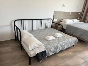 a bedroom with two beds with towels on them at AKAMAS THRONE APARTMENTS in Neo Chorio +66 photos