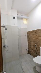 a bathroom with a shower and a toilet at Riverline Resort Kandy in Kandy +29 photos