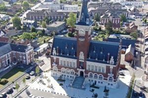 an aerial view of a building with a clock tower at L'évasion du Coquelicot in Albert