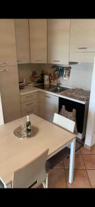 a kitchen with a table and a sink and a stove at 80vogliadirelax in Rome
