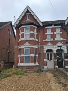 a red brick house with a white door at Sunny Southampton 3 Bedroom Apartment in Southampton