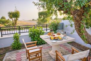 a table with food on it sitting on a patio at Villa Amor in Pefki