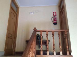 a staircase with a fire extinguisher on the wall at La Abuela Maye y Me in Carrión de los Condes