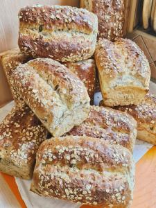a pile of breads sitting on top of a table at A morze! Agroturystyka Nowy Kraków pod Darłowem in Jeżyce +43 photos
