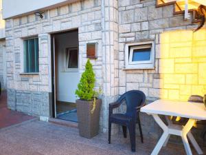 a table and two chairs in front of a building at Na brigu in Livno