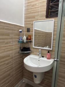 a bathroom with a sink and a mirror at Cozy Stay Near Zanzibar Airport in Zanzibar City +9 photos