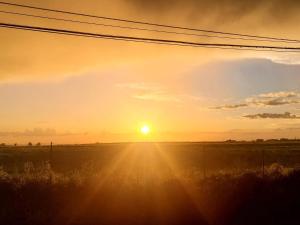a sunset over a field with the sun in the sky at 80vogliadirelax in Rome