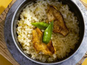 a bowl of rice with fried fish and green peppers at KOKO HOTEL Kanazawa Station in Kanazawa
