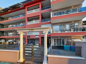 an apartment building with columns and a balcony at APOLLON Suites by SDR in Paralia Katerinis