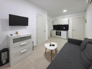 a living room with a couch and a table at APOLLON Suites by SDR in Paralia Katerinis