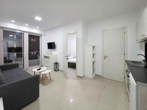 a living room with a couch and a room with a bedroom at APOLLON Suites by SDR in Paralia Katerinis +4 photos