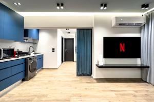 a kitchen with a tv on the wall at The 2 BDR Sapphire Condo U 5 min to CAI Airport in Cairo