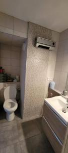 a bathroom with a toilet and a sink at Studio LE CORBIER in Villarembert