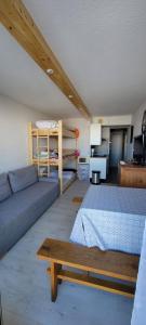a living room with a bed and a couch at Studio LE CORBIER in Villarembert