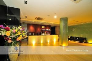 a lobby with a bar and a vase of flowers at D North Star Hotel & Spa in Bandar Indah