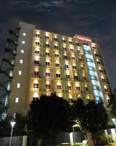 a large hotel building with lights on at Hotel Cikini in Jakarta