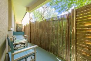 a patio with two chairs and a fence at Le Mérignac Cozy Corner - T3 & Terrasse in Mérignac +14 photos