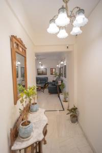 a living room with potted plants on a table at Kutani Stays - Civil Lines in Jaipur +11 photos