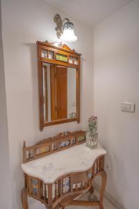 a bathroom with a dressing table and a mirror at Kutani Stays - Civil Lines in Jaipur