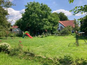 a yard with a playground in the grass at APARTMÁN ČESKÁ KANADA in Nová Bystřice