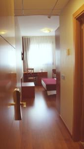 Postel nebo postele na pokoji v ubytování Hotel Reus Park