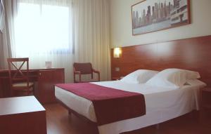 Postel nebo postele na pokoji v ubytování Hotel Reus Park