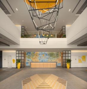 a large room with a lobby with a large ceiling at HIIVE by fusion Binh Duong - VSIP 1 in Thuan An